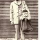 Letter carrier with a cozy looking baby (Image via National Postal Museum)